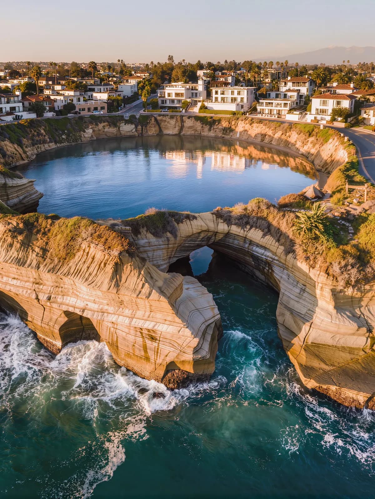 Vertical editorial photograph of La Jolla's dramatic coastal cliffs and cove