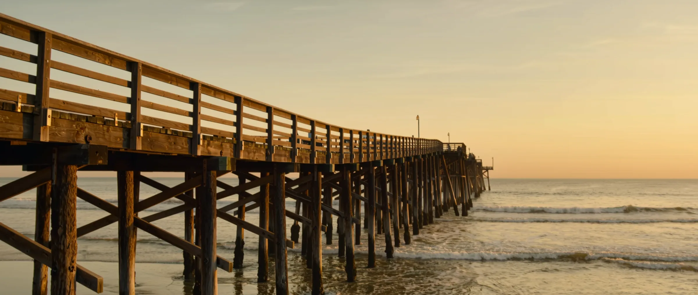 Wide cinematic view of the Oceanside pier and coastline