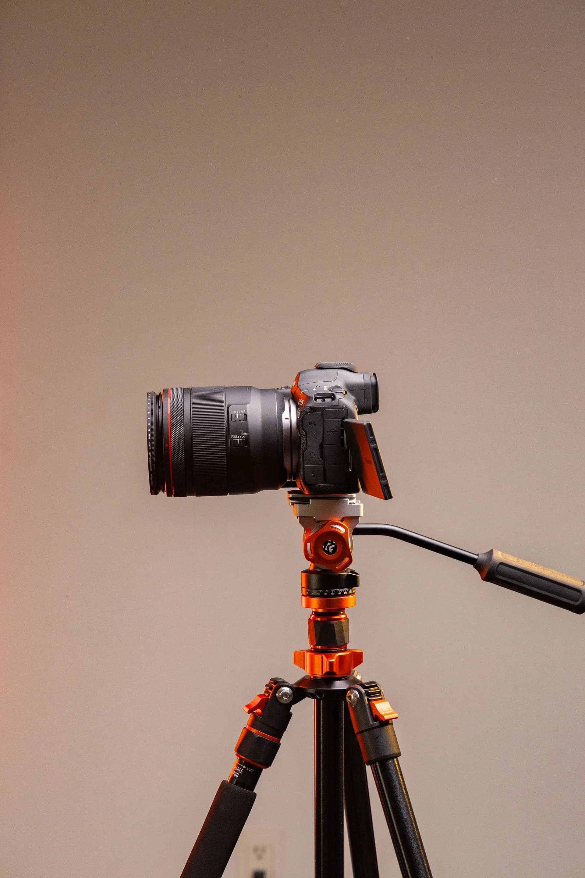 A professional camera mounted on a tripod, set up for a photography shoot